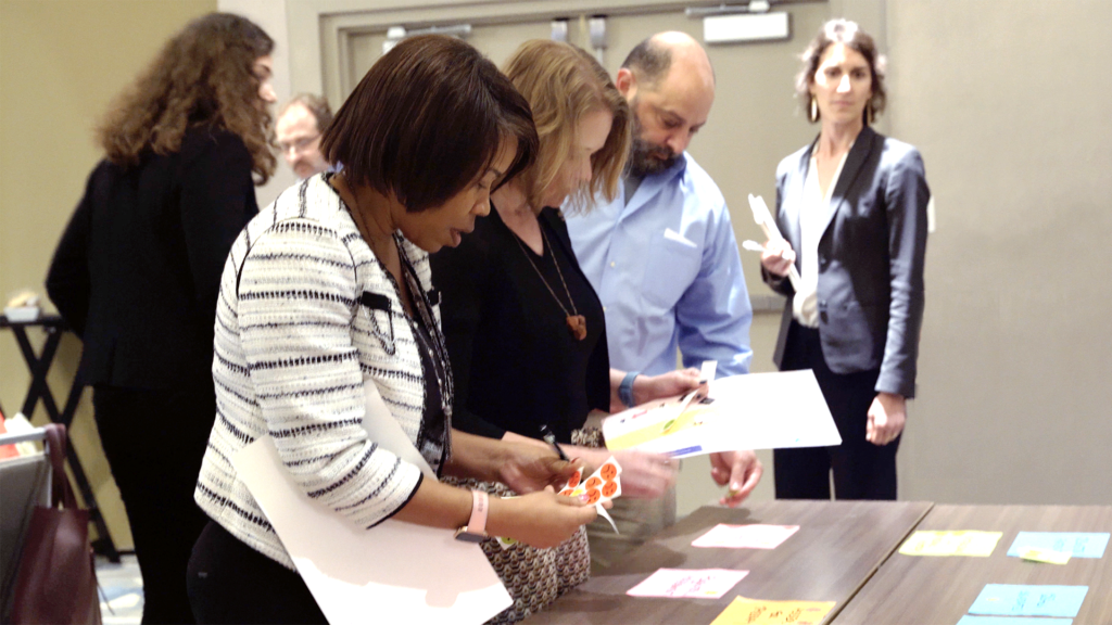 People around a table looking at documents